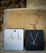 Silver-plated infinity earrings and pendant. 